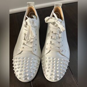 Men’s white low tops with spikes Christian Louboutin sneakers. In good condition